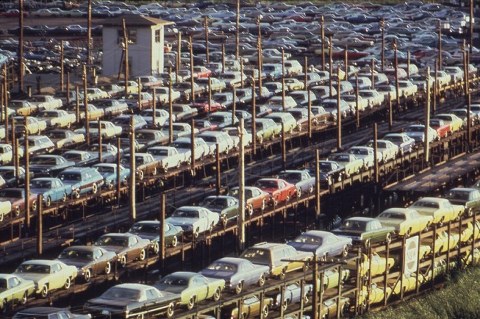 New cars loaded onto railroad cars at Lasher and I-75 in Detroit, in 1973. Photo by Joe Clark. Source: Wikipedia